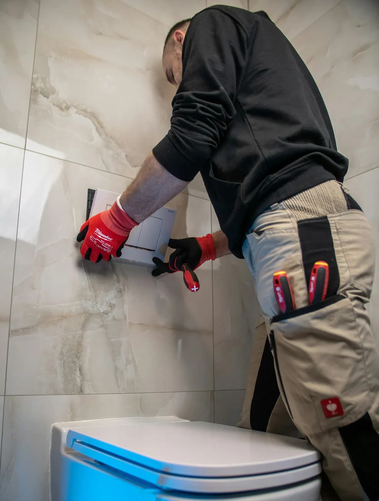 Engineer working on a toilet in a bathroom